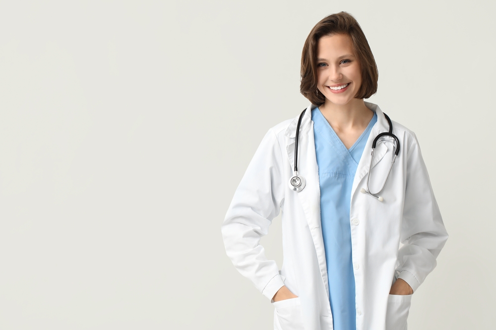 female doctor smiling off white background